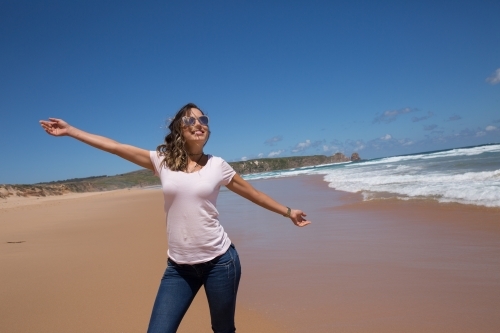 Woman enjoying summer sun on Woolamai Beach - Australian Stock Image
