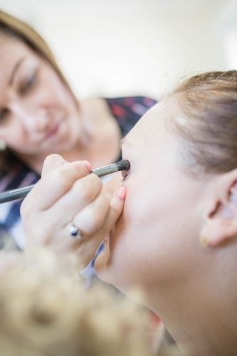 Woman getting eye makeup done - Australian Stock Image