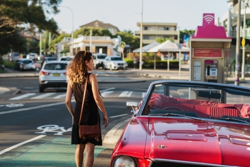 woman getting into classic car - Australian Stock Image