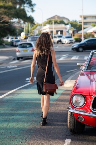 woman getting into classic car - Australian Stock Image