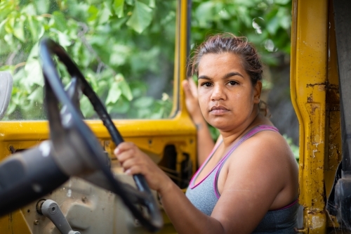 woman getting into old mustard coloured landcruiser - Australian Stock Image