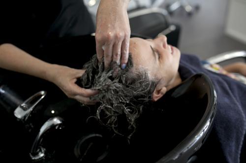 Woman having hair washed at hairdressing salon - Australian Stock Image