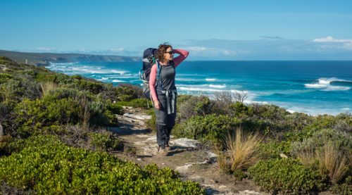 Woman hiking Kangaroo Island Wilderness Trail near ocean - Australian Stock Image