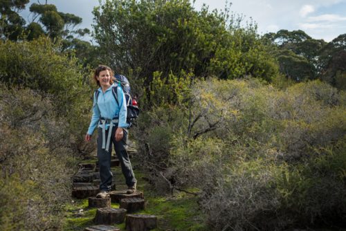 Woman hiking Kangaroo Island Wilderness Trail with backpack - Australian Stock Image