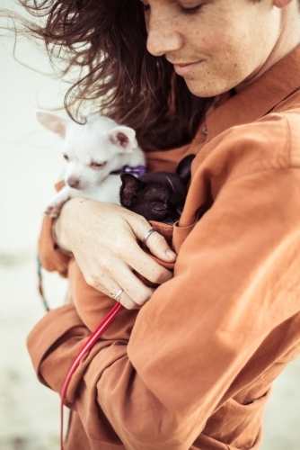 Woman holding small dogs