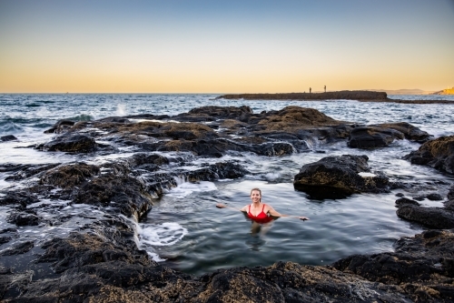 Woman in coastal rock pool