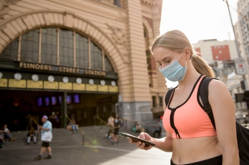 Woman in Face Mask Waiting at Flinders Street Station - Australian Stock Image