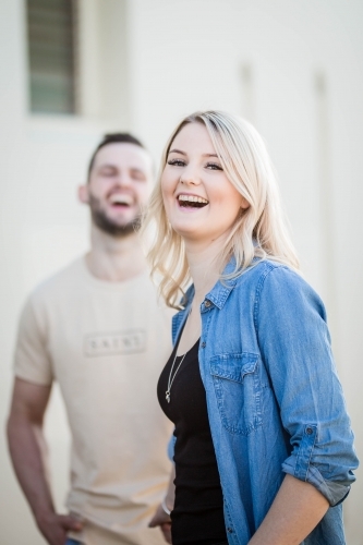 Woman laughing with man in background - Australian Stock Image