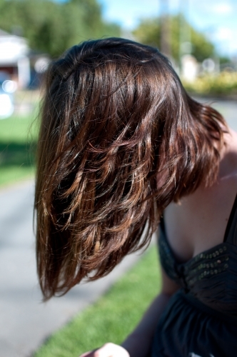 Woman leaning forward with long hair - Australian Stock Image