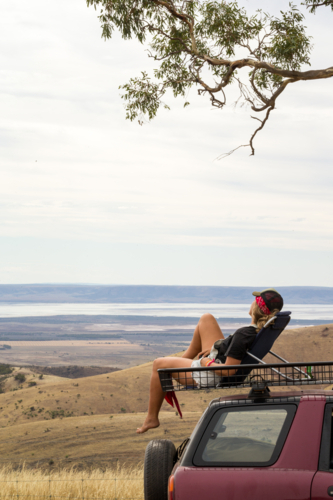 Woman on a road trip looking out at view - Australian Stock Image