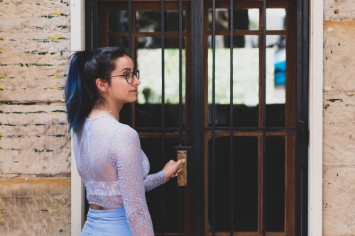 woman opening door - Australian Stock Image