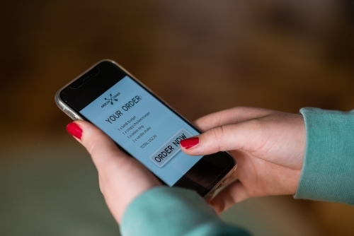 woman ordering takeaway food online - Australian Stock Image