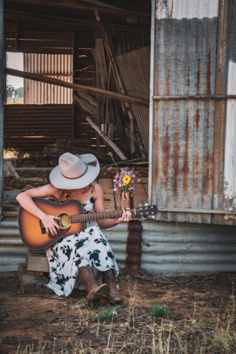 Woman playing a guitar - Australian Stock Image