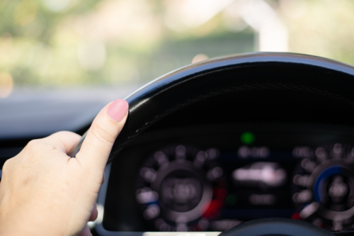woman's hand on steering wheel - Australian Stock Image