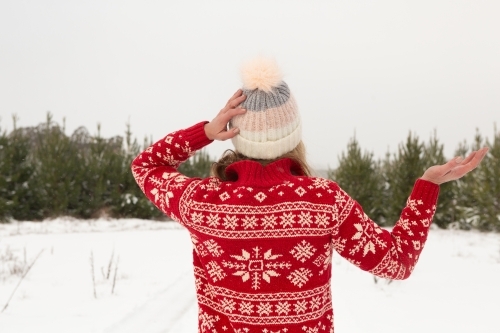 Woman standing in a winter landscape covered in snow - Australian Stock Image
