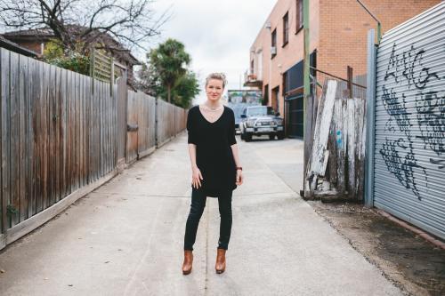 Woman standing in urban laneway - Australian Stock Image