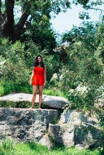 woman standing on a rock - Australian Stock Image
