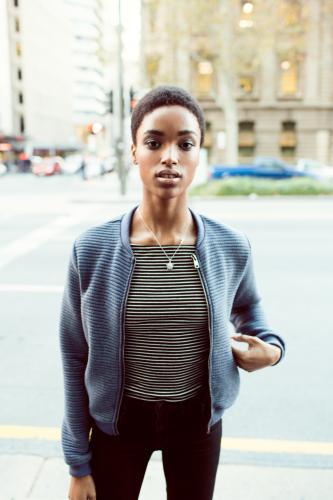 Woman standing on the street in the city - Australian Stock Image