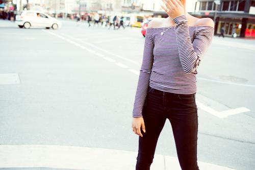 Woman standing on the street laughing - Australian Stock Image