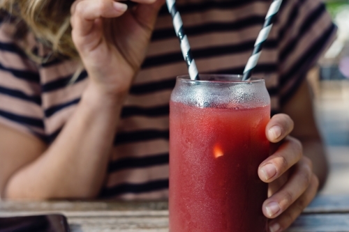 woman using paper straw - Australian Stock Image