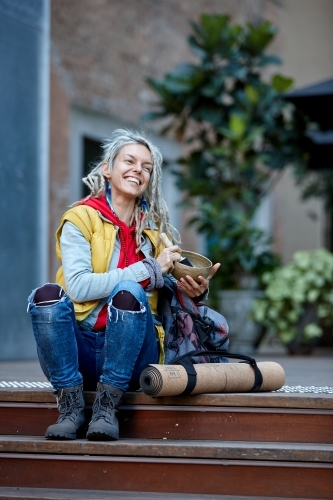 Woman using Tibetan singing bowl - Australian Stock Image