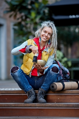 Woman using Tibetan singing bowl - Australian Stock Image