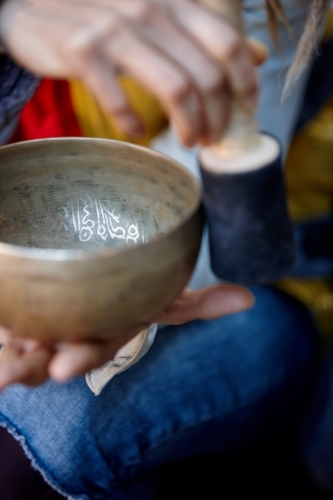 Woman using Tibetan singing bowl