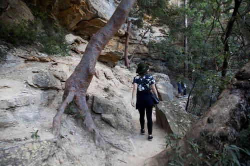 Woman walking along path in bush - Australian Stock Image