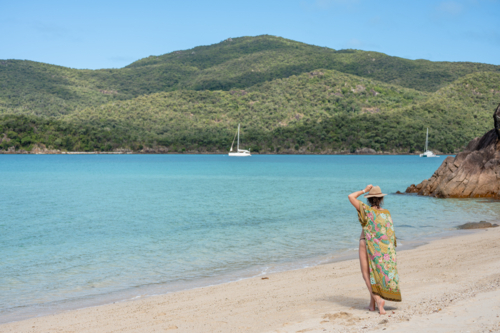 woman walking on white sand beach - Australian Stock Image