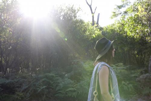Woman walking through bush to the beach - Australian Stock Image