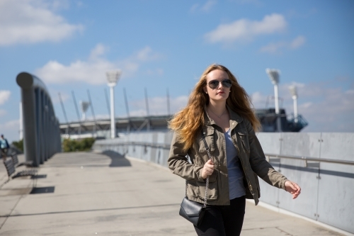 Woman Walking to the City from the MCG - Australian Stock Image