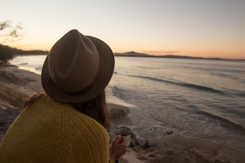 Woman watching sunset at beach