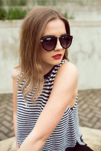 Woman wearing a striped top and sunglasses