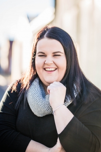 Woman with long dark hair laughing - Australian Stock Image