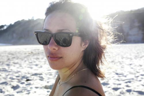 Woman with sunglasses on at beach