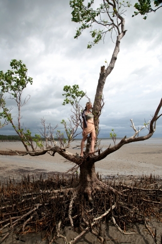 Women standing on tree branch in outback Australia - Australian Stock Image