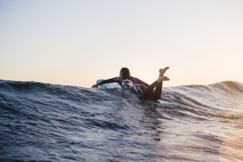 Women surfing over wave at sunset Phillip Island