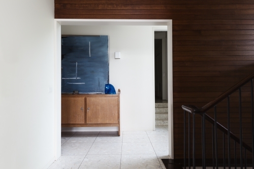 Wood panel wall detail and entry foyer in mid century modern home - Australian Stock Image