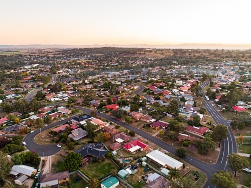 Wood smoke collecting over houses in town at dusk - Australian Stock Image