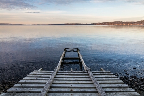 wooden boat ramp into water - Australian Stock Image
