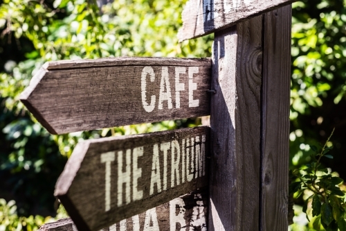 wooden direction sign in a farmers market - Australian Stock Image