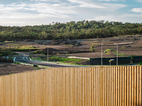Wooden fence in front of unfinished residential development - Australian Stock Image