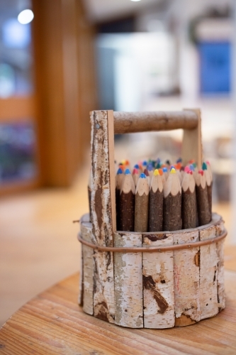 Wooden pencil holder with coloured pencils - Australian Stock Image