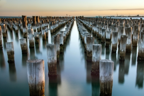 Wooden posts left behind in water at pier at Port Melbourne - Australian Stock Image
