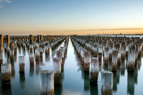 Wooden posts left behind in water at pier at Port Melbourne - Australian Stock Image
