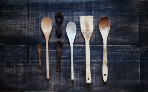 Wooden spoons on dark background