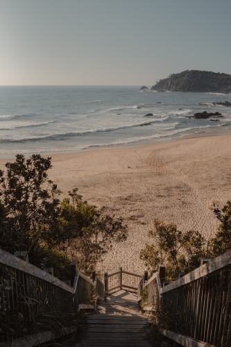 Wooden stairs leading to a secluded beach. - Australian Stock Image