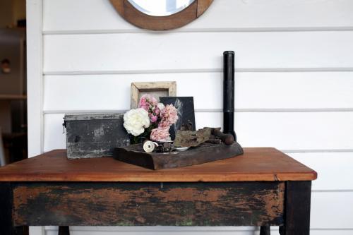 Wooden table with roses and vintage decorations - Australian Stock Image