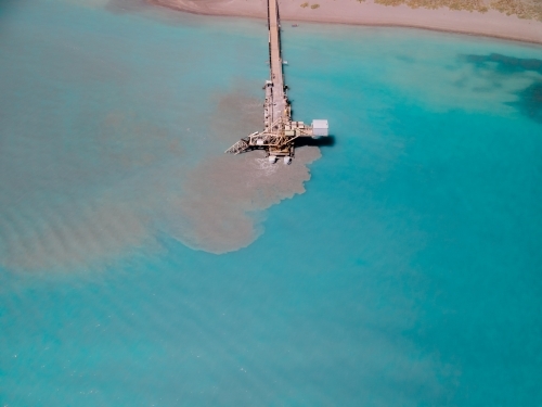 Top down view industrial wharf in clear waters at Woodman Point
