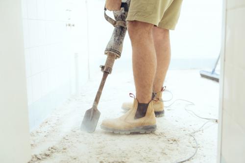 Workman jackhammering on construction site - Australian Stock Image